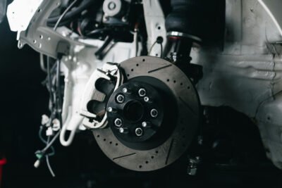 mechanic replacing worn brake pads